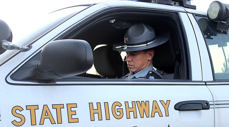 Ohio State Highway Patrol trooper Jason Hodge of the Springfield Post writes up a report in his patrol car. Jeff Guerini/Staff