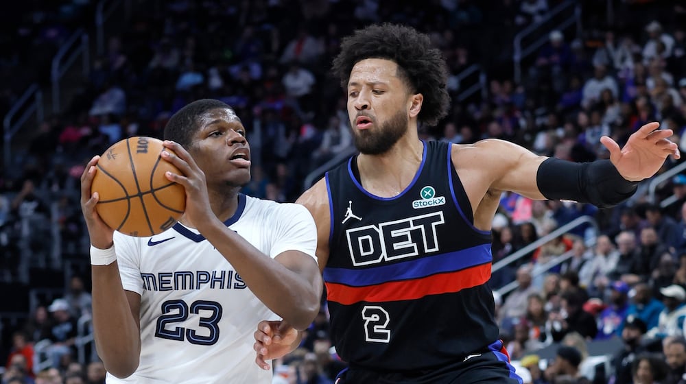 Memphis Grizzlies forward Cedric Coward (23) drives against Detroit Pistons guard Cade Cunningham (2) during the first half of an NBA basketball game Friday, March 13, 2026, in Detroit. (AP Photo/Duane Burleson)