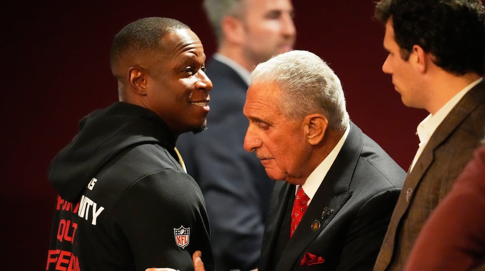 Atlanta Falcons owner Arthur Blank, right, hugs head coach Raheem Morris after an NFL football game against the New Orleans Saints, Sunday, Jan. 4, 2026, in Atlanta. (AP Photo/Mike Stewart)