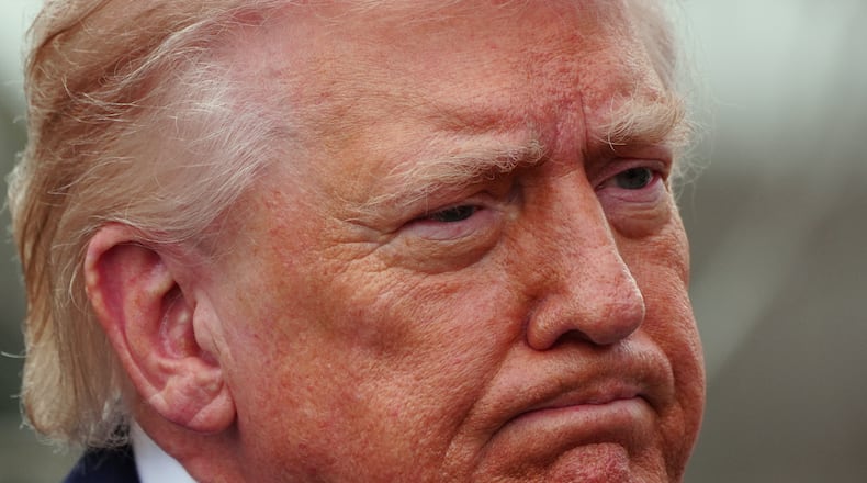 President Donald Trump speaks with reporters before departing on Marine One from the South Lawn of the White House, Friday, March 20, 2026, in Washington. (AP Photo/Alex Brandon)