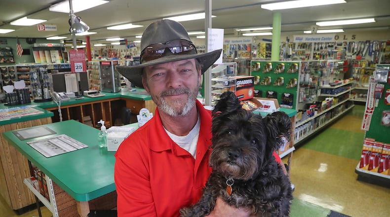 Brant Cornelison, the new owner of the Brain Lumber Company on East Street in Springfield, with "Charlie" in the hardware section of the business Wednesday, Oct. 26, 2022. Brant started working at the 154-year-old business when he was 14 years old. BILL LACKEY/STAFF