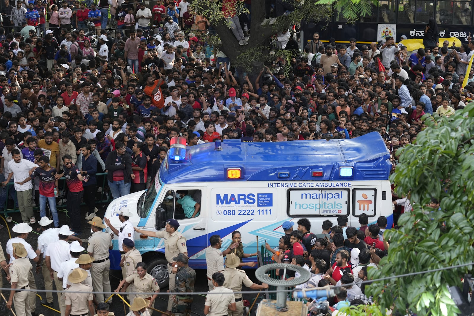 An ambulance arrives at the M. Chinnaswamy Stadium as fans gather to celebrate Royal Challengers Bengaluru cricketers, winners of the Indian Premier League, in Bengaluru, India, Wednesday, June 4, 2025. (AP Photo/Aijaz Rahi)