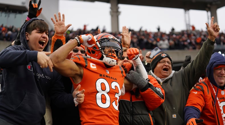 Cincinnati Bengals wide receiver Tyler Boyd (83) celebrates a 5-yard touchdown with fans during the second half of an NFL football game against the Kansas City Chiefs, Sunday, Jan. 2, 2022, in Cincinnati. (AP Photo/Jeff Dean)