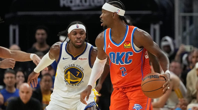 Oklahoma City Thunder guard Shai Gilgeous-Alexander (2) brings the ball up the court against Golden State Warriors guard Buddy Hield (7) during the first half of an NBA basketball game in San Francisco, Tuesday, Dec. 2, 2025. (AP Photo/Jeff Chiu)