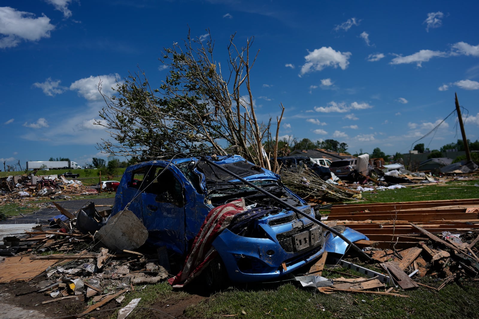 A vehicle is covered in debris after a severe storm passed the area on Saturday, May 17, 2025 in London, Ky. (AP Photo/Carolyn Kaster)