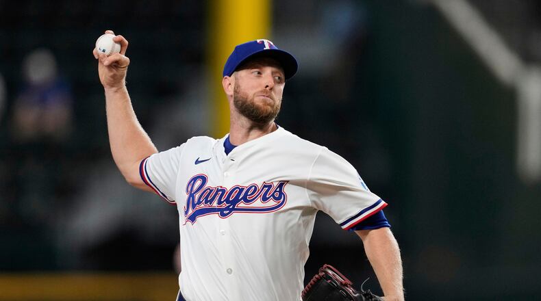 FILE - Texas Rangers starting pitcher Merrill Kelly throws to the Arizona Diamondbacks in the first inning of a baseball game, Aug. 13, 2025, in Arlington, Texas. (AP Photo/Tony Gutierrez, File)