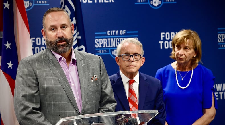 The city of Springfield School District Superintendent Dr. Robert Hill, with Ohio Governor Mike DeWine, and his wife Fran, answer questions at a press conference Tuesday, September 17, 2024 at City Hall in Springfield. MARSHALL GORBY / STAFF