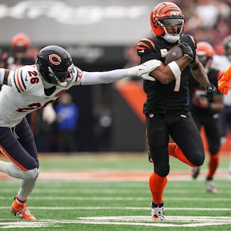 Chicago Bears cornerback Nahshon Wright (26), left, tries to grab Cincinnati Bengals wide receiver Ja'Marr Chase (1) as he runs the ball during the first half of an NFL football game, Sunday, Nov. 2, 2025, in Cincinnati. (AP Photo/Jeff Dean)