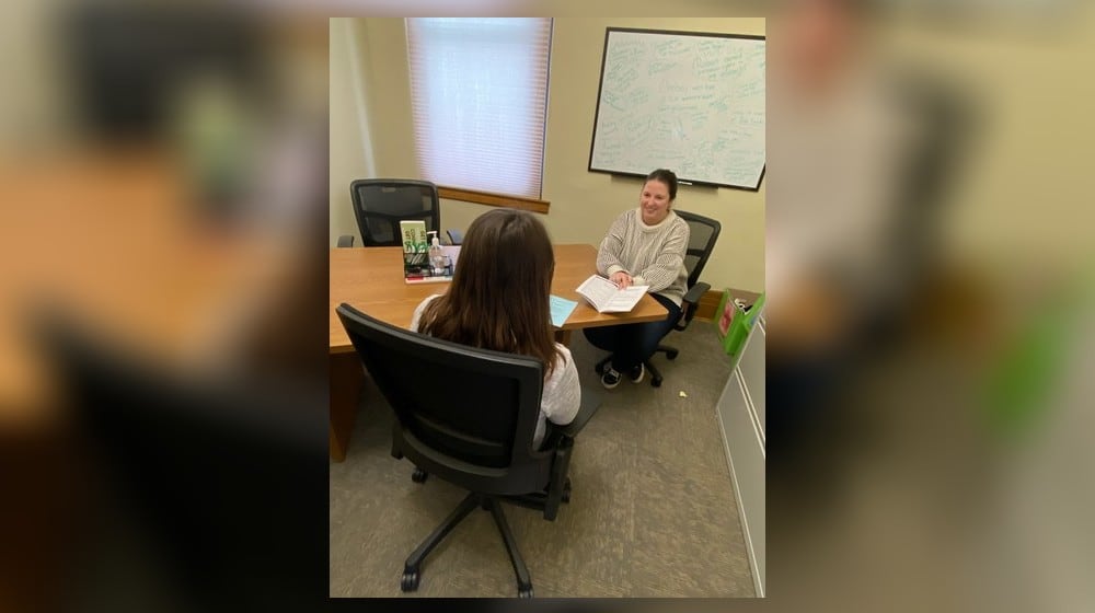 Clark County Department of Reentry Housing Specialist, McKenzie Burton, helps a community member review tenant rights. CONTRIBUTED