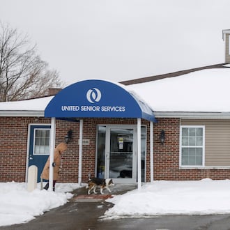 A woman walks her dog into United Senior Services on Tuesday, Feb. 3, 2026 in New Carlisle. This location suspended meals and activities due to low attendance. JOSEPH COOKE / STAFF