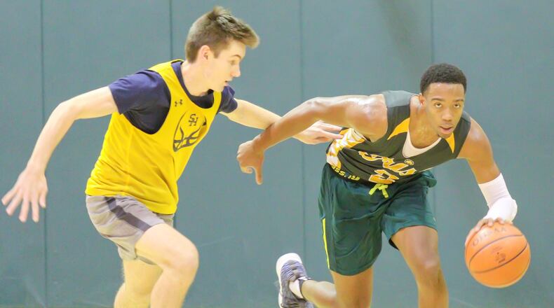 Catholic Central senior Sabien Doolittle dribbles past a Cincinnati Seven Hills defender during their scrimmage game at Jason Collier Gymnasium on Tuesday, Nov. 20. The Irish return seven seniors from a team that advanced to the Division VI regional semifinals last season. CONTRIBUTED PHOTO BY MICHAEL COOPER