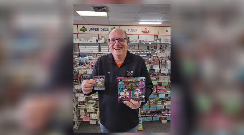Terry Carter, owner of TCI Sports Fan in Dayton, holds a $1,200 box of 2020 Illusions Football and an unautographed $10 Joe Burrow rookie card from 2020 Panini. SUBMITTED PHOTO