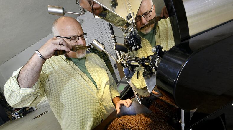 Paul Kurtz, owner of Hemisphere Roasters in Mechanicsburg, smells the freshly roasted coffee beans as they cool after coming out of the roaster in his warehouse location in 2014. Bill Lackey/Staff