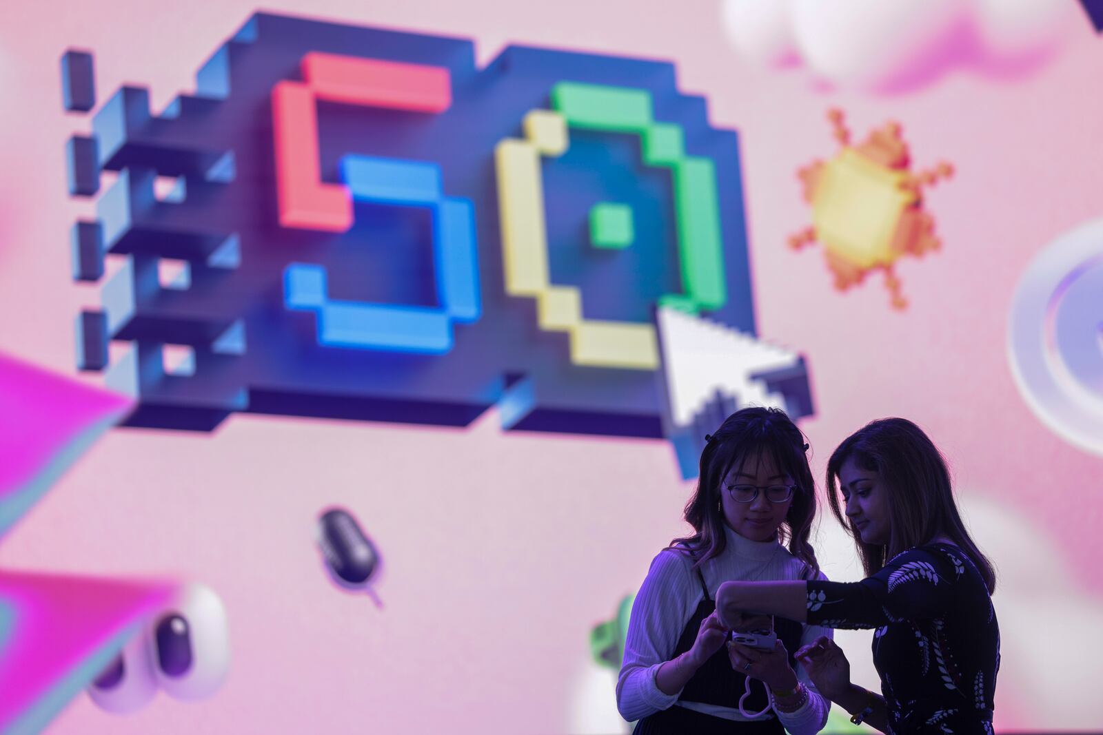 Attendees are pictured before a presentation of the Microsoft's AI assistant, Copilot, and celebration of the company's 50th anniversary at Microsoft headquarters, Friday, April 4, 2025, in Redmond, Wash. (AP Photo/Jason Redmond)