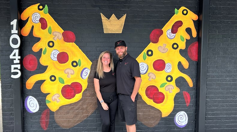 Owners Ashley and Mike Estep pose in front of a mural at their restaurant The Villa Pizzeria on Friday, Sept. 2, 2023. JESSICA OROZCO/STAFF