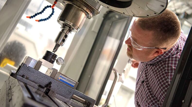 Clark State Community College is ready to help with applications for Ohio’s TechCred Program, in which the school was approved to add over 20 new training programs. This is Business and Applied Tech instructor Jason Chilman a few years ago as he checks out one of the machines in a manufacturing lab. CONTRIBUTED