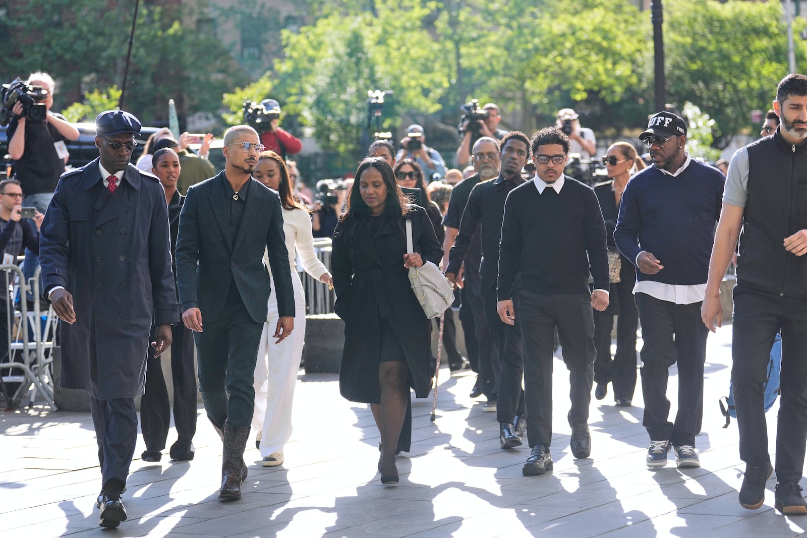 Family and supporters of Sean "Diddy" Combs, including his sons Quincy Brown, second from left, and Justin Combs, third from right, arrive to the courthouse in New York, Monday, May 12, 2025. (AP Photo/Seth Wenig)