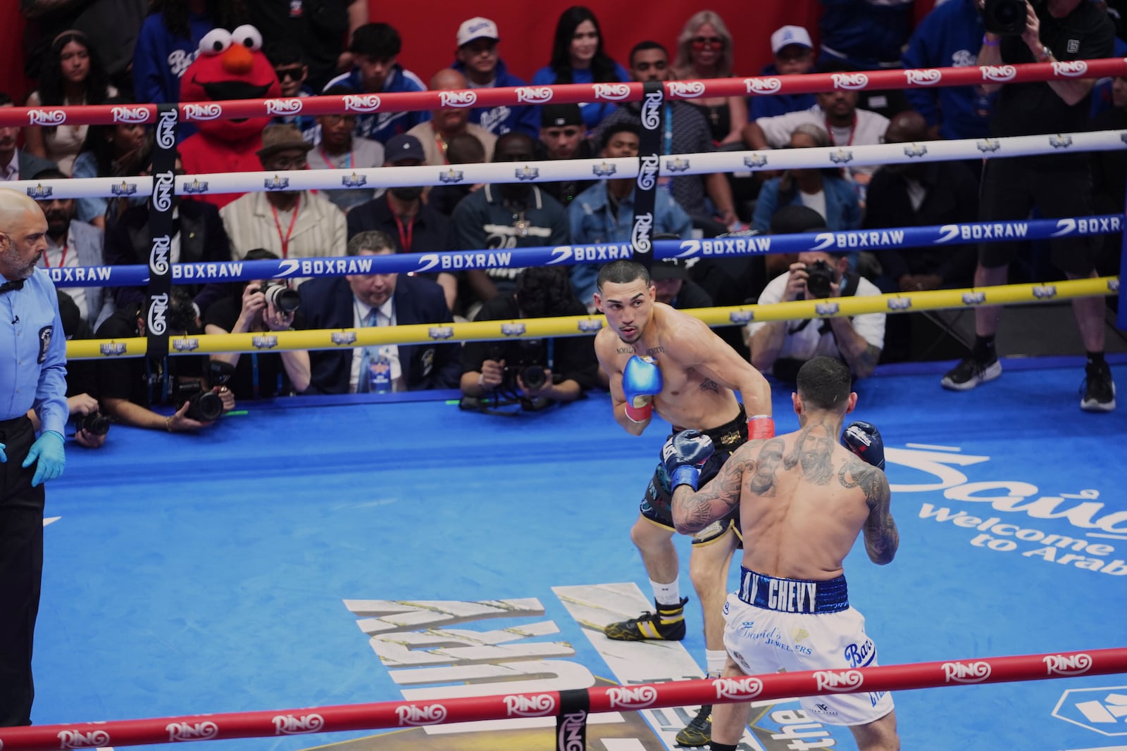 People watch as Teofimo Lopez, left, fights Arnold Barboza Jr. during a super lightweight boxing match in Times Square Friday, May 2, 2025, in New York. (AP Photo/Frank Franklin II)