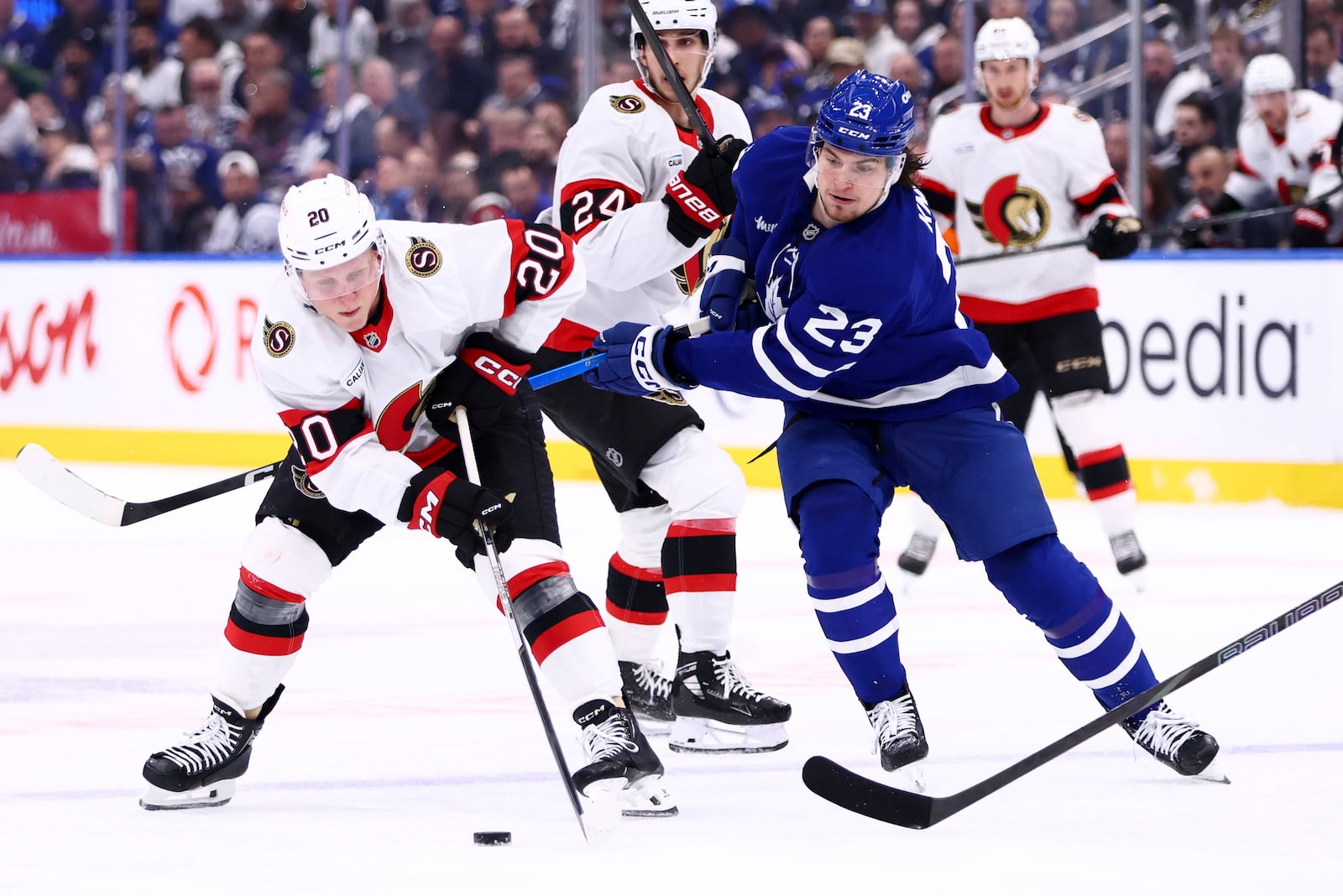 FILE - Ottawa Senators' Fabian Zetterlund (20) and Toronto Maple Leafs' Matthew Knies (23) battle for the puck during the first period of an NHL hockey playoff game in Toronto, on Tuesday, April 22, 2025. (Cole Burston/The Canadian Press via AP, File)
