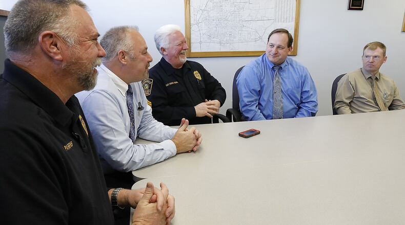 Five senior police officers with the Springfield Police Division, who are retiring next year, share some memories from their years of experience on the police force. They are, from left, Officer Mark Parsons, Capt. Mike Hill, Sgt. Barry Eggers, Officer Allen Icenhour, Officer Tim Barcus. Bill Lackey/Staff