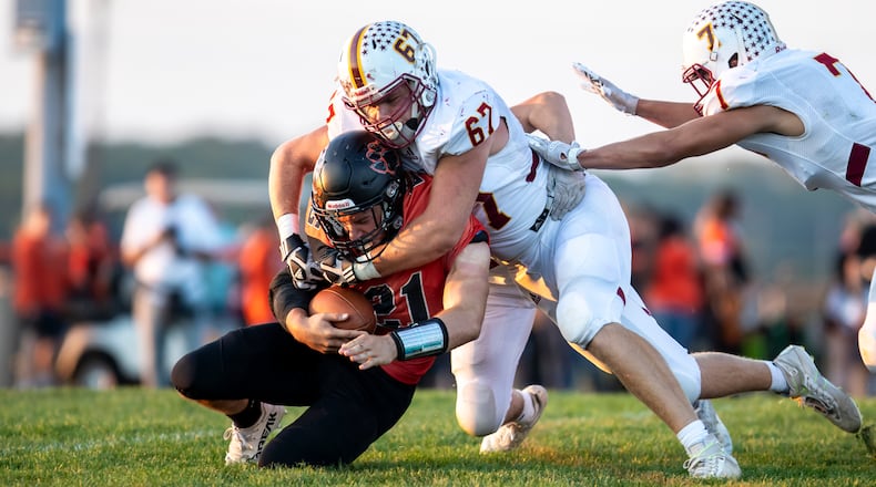 Northeastern's Brady Gilliam tackles West Liberty-Salem's Gabe McGill on Friday, Sept. 22, 2023, at West Liberty. Michael Cooper/CONTRIBUTED
