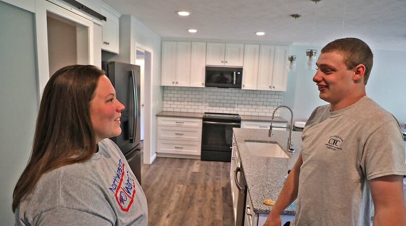 Tommy Rowe, senior CTC students who worked on the CTC 2019 project house, talks with Lynn Cochran, the owner of the new house, during the open house Tuesday. Students showed up at the beginning of the school year to find only a basement and as the year draws to an end, the house is complete. BILL LACKEY/STAFF