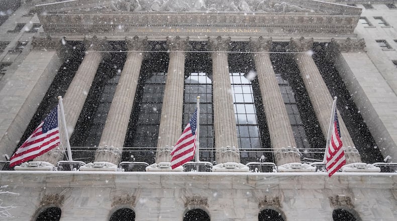 Snow falls outside the New York Stock Exchange, Monday, Feb. 23, 2026, in New York. (AP Photo/Seth Wenig)