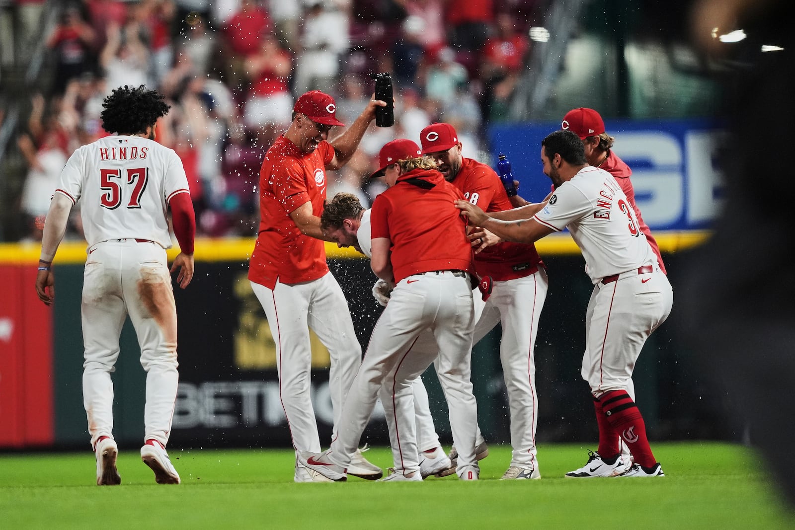 Teammates celebrate with Cincinnati Reds' Gavin Lux, center, after he hit an RBI single to score Elly De La Cruz and win the game during the eleventh inning of a baseball game against the New York Yankees, Tuesday, June 24, 2025, in Cincinnati. (AP Photo/Joshua A. Bickel)