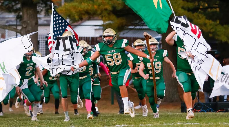 Catholic Central High School senior Ivan Escamilla (58) leads the Irish onto the field before their game against Greenon at Hallinean Field earlier this season. CONTRIBUTED PHOTO BY MICHAEL COOPER
