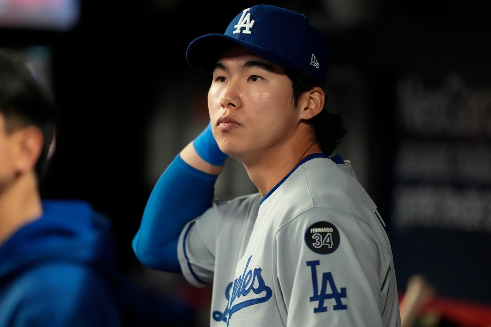 Los Angeles Dodgers' Hyeseong Kim stands in the dugout in the ninth inning of a baseball game against the Atlanta Braves, Sunday, May 4, 2025, in Atlanta. (AP Photo/Mike Stewart)