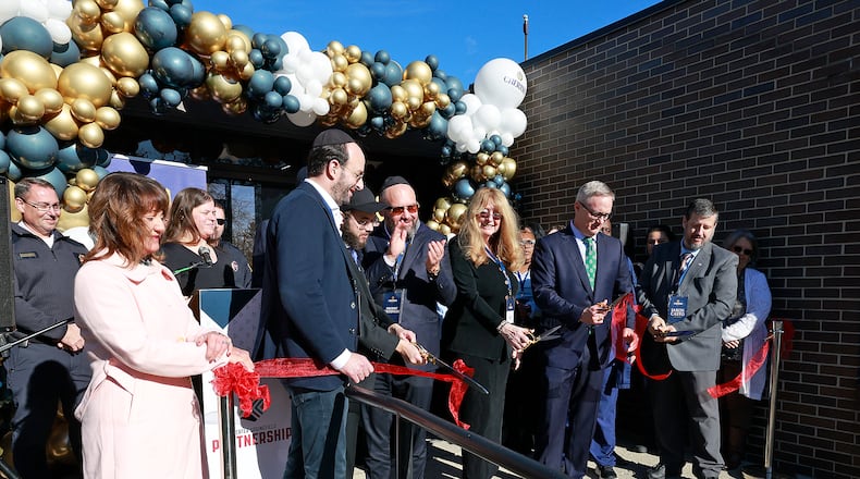 Officials from Cherish Hospice and the City of Springfield held a ribbon cutting ceremony for the new Cherish Hospice's new Ohio headquarters on East High Street Tuesday, Dec. 17, 2024. BILL LACKEY/STAFF