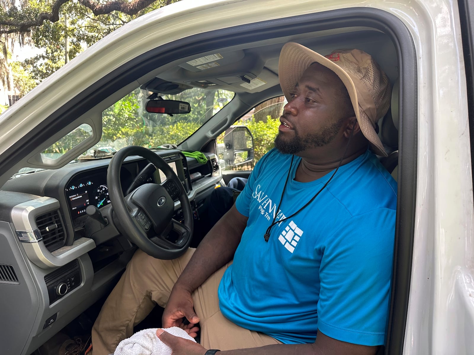 Darius Cowherd takes a break from his city landscaping job in Savannah, Ga., Tuesday, July 29, 2025, as people across the South dealt with extreme summer heat. (AP Photo/Russ Bynum)