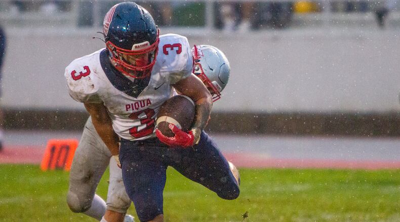 Piqua senior running back Jasiah Medley scores a touchdown in the rain against Troy in the first half Friday night at Troy. Jeff Gilbert/CONTRIBUTED