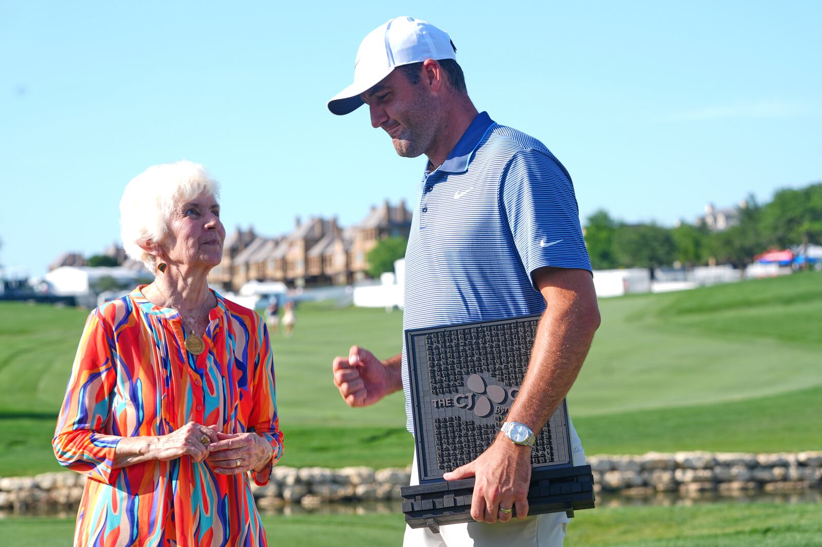 Scottie Scheffler, right, has a moment with Peggy Nelson, left, the wife of the late Byron Nelson, after Scheffler won the CJ Cup Byron Nelson golf tournament in McKinney, Texas, Sunday, May 4, 2025. (AP Photo/LM Otero)
