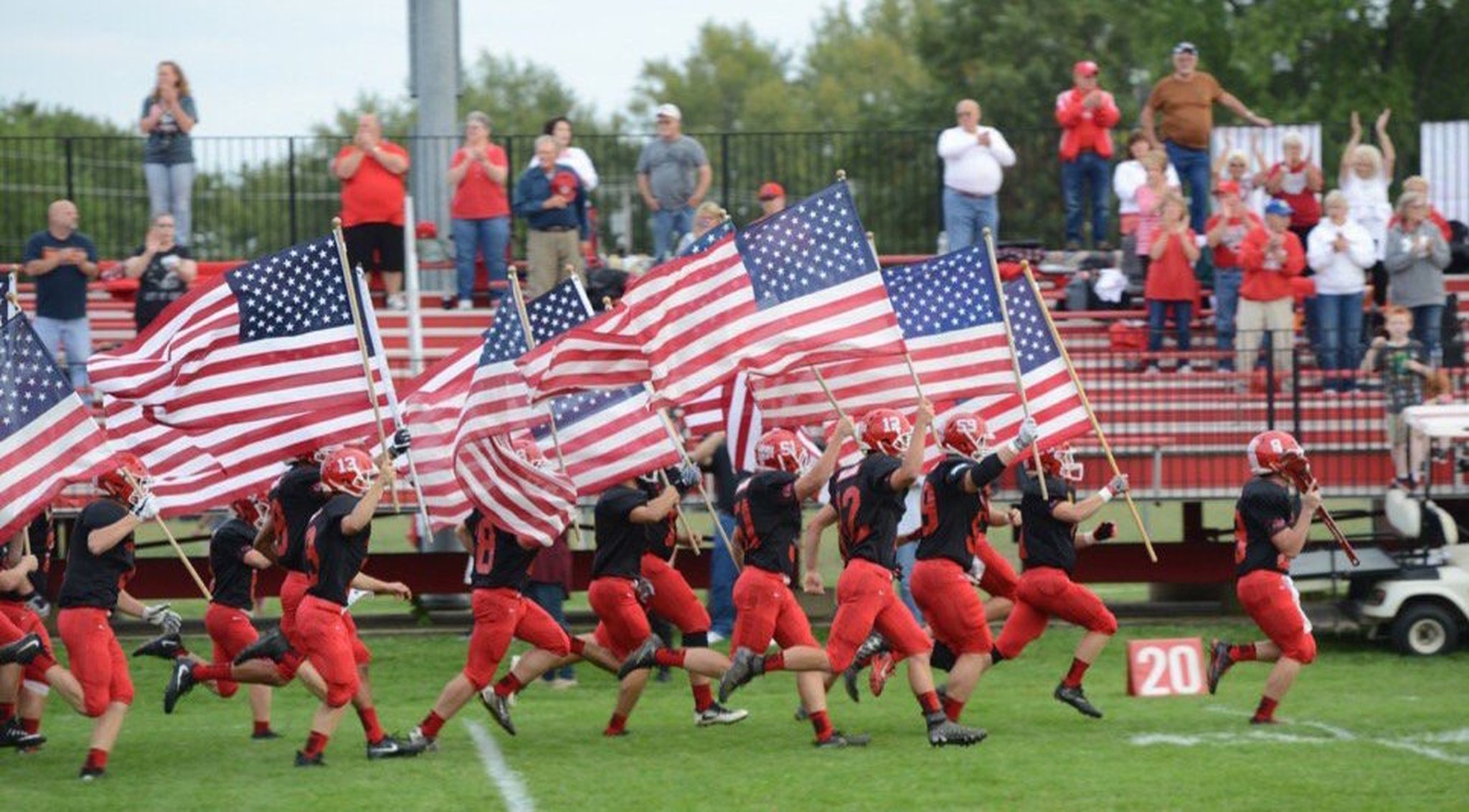 Milton-Union High School football players take the field waving American flags to honor the U.S. response to 9/11. Milton-Union defeated visiting Northridge 69-35 in the Week 4 SWBL game on Friday, Sept. 15, 2017. CONTRIBUTED PHOTO