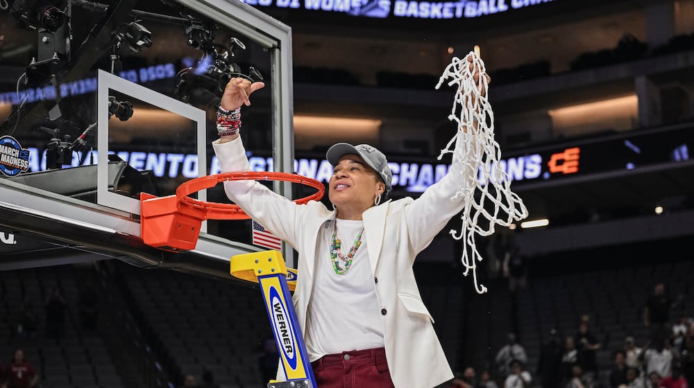 South Carolina head coach Dawn Staley celebrates cutting down the net after South Carolina beats TCU in the Elite Eight of the NCAA college basketball tournament Monday, March 30, 2026, in Sacramento, Calif. (AP Photo/Justine Willard)
