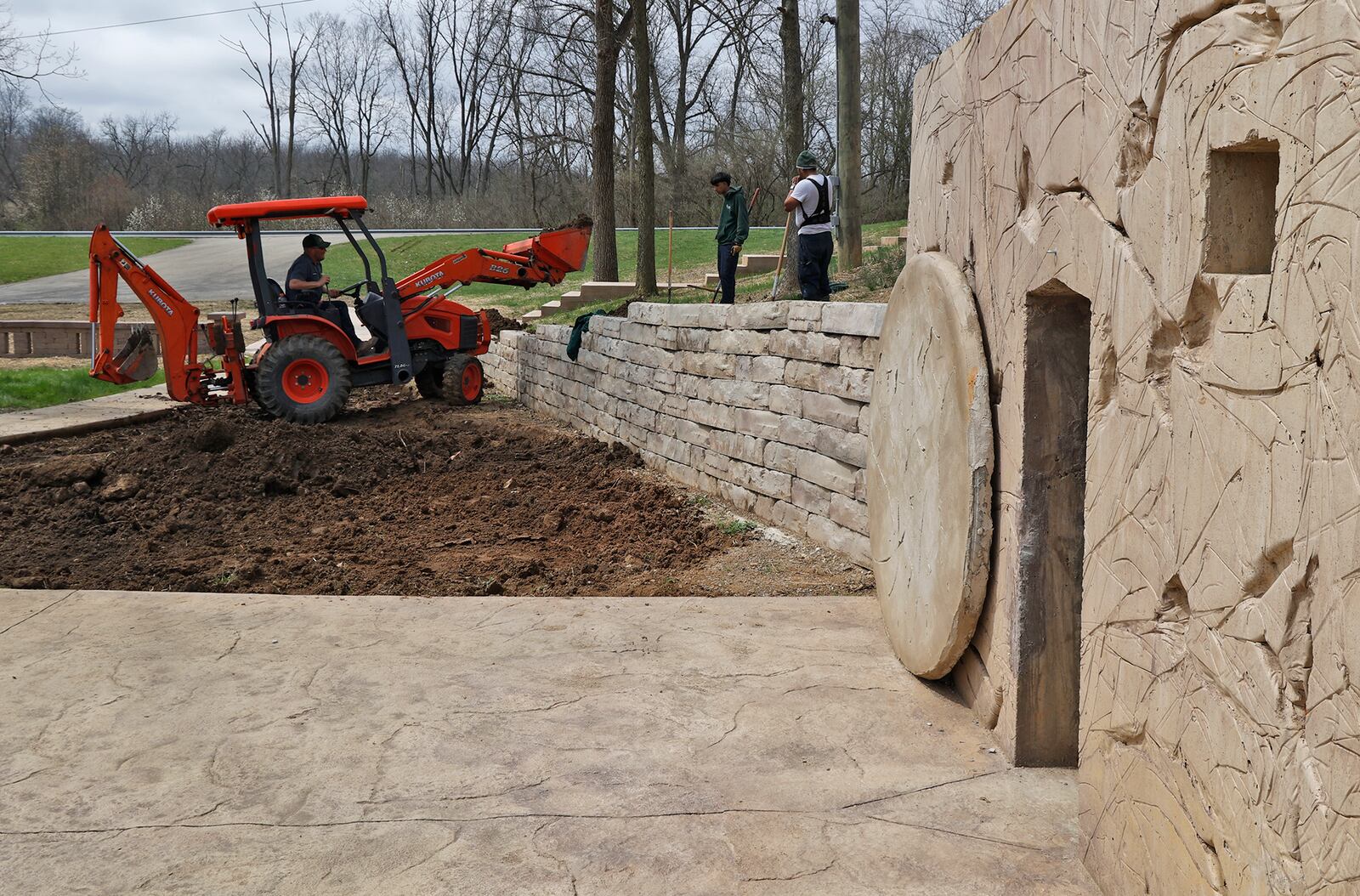 A landscaping crew from Siebenthaler's Landscaping works on the surrounding landscaping at the Berea Bible Church's Resurrection Garden Tuesday, April 4, 2023. BILL LACKEY/STAFF