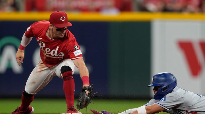 Cincinnati Reds second baseman Matt McLain, left, is late with the tag as Los Angeles Dodgers Miguel Rojas is safe at second base on a double during the fifth inning of a baseball game, Monday, July 28, 2025, in Cincinnati. (AP Photo/Carolyn Kaster)