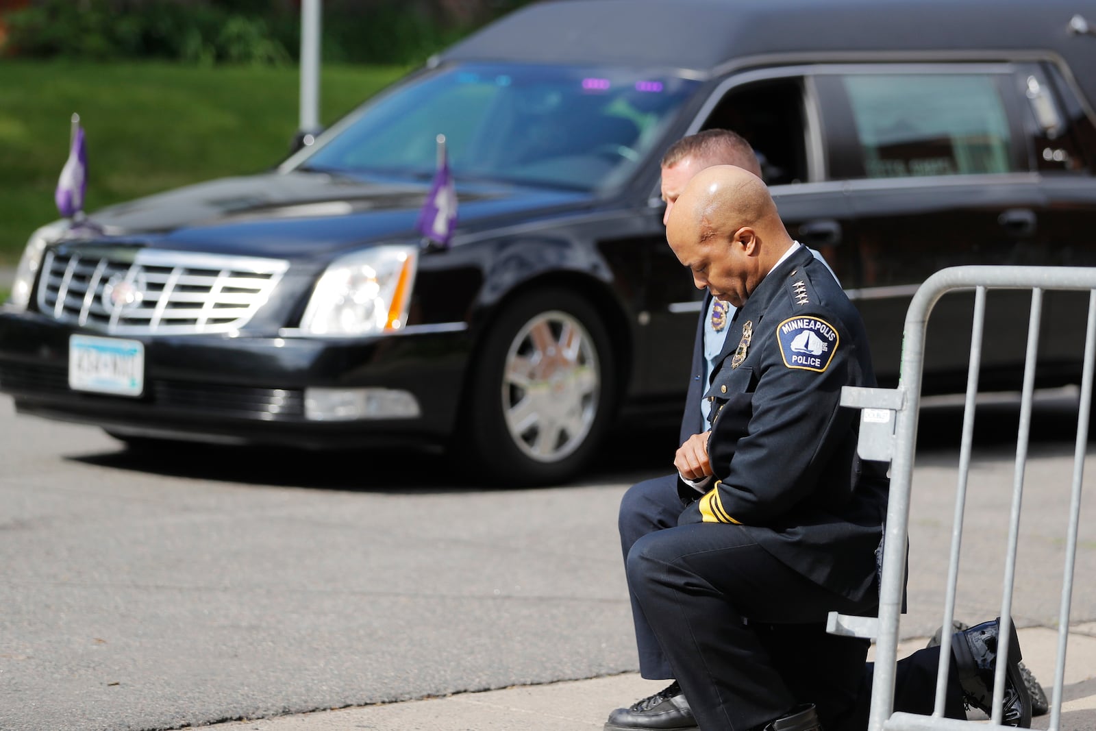 FILE - Police officers, including Minneapolis Police Chief Medaria Arradondo, foreground, take a knee as the body of George Floyd arrives before his memorial services in Minneapolis on June 4, 2020. (AP Photo/Julio Cortez, File)