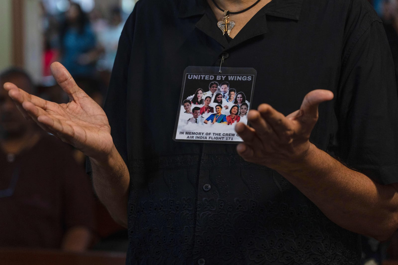 A man offer prayers for crew members of Air India flight that crashed in Ahmedabad last month during a prayer meeting at a church in Mumbai, India, Saturday, July 12, 2025. (AP Photo/ Rafiq Maqbool)