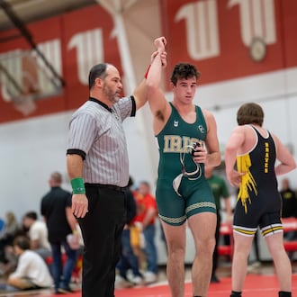 Catholic Central High School senior Brody Adamas has he arm raised by an official after winning a match at the Clark County Clash earlier this season at Wittenberg University. CONTRIBUTED PHOTO