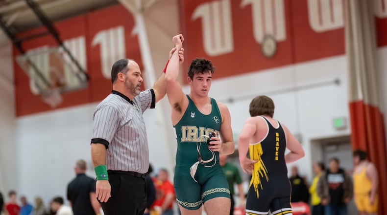 Catholic Central High School senior Brody Adamas has he arm raised by an official after winning a match at the Clark County Clash earlier this season at Wittenberg University. CONTRIBUTED PHOTO