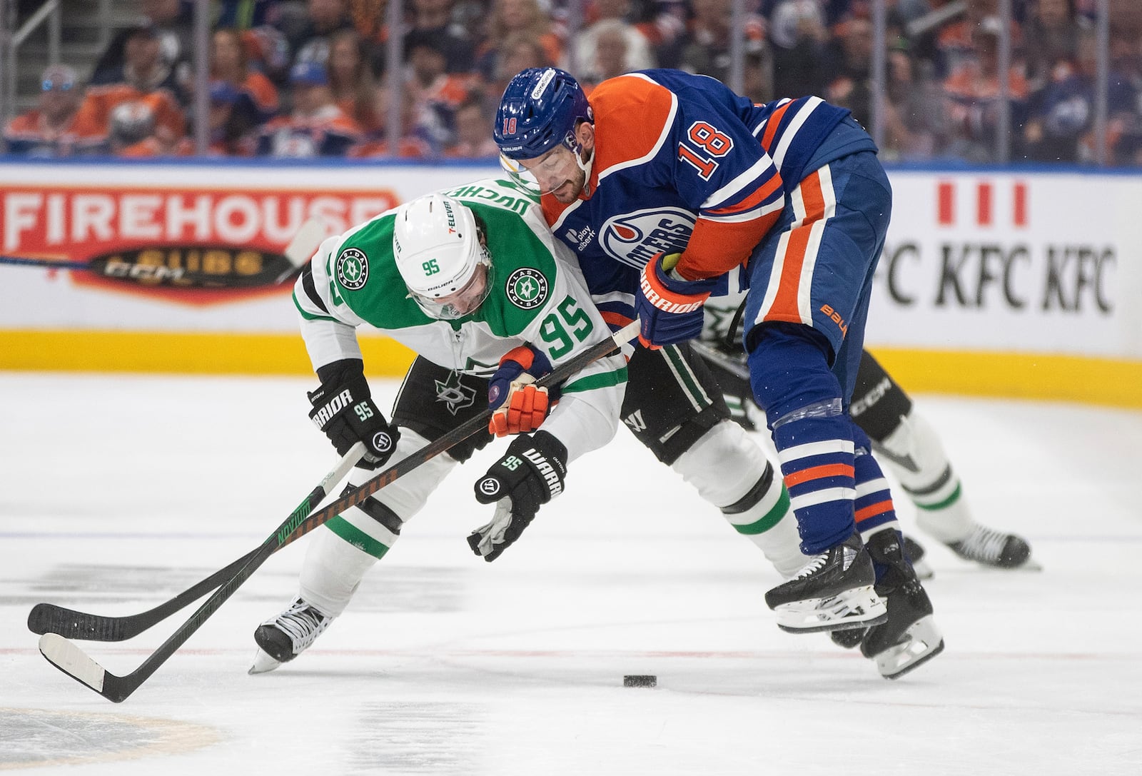 Dallas Stars' Matt Duchene (95) and Edmonton Oilers' Zach Hyman (18) battle for the puck during the second period of Game 3 of the NHL hockey Stanley Cup Western Conference final in Edmonton, Alberta, Sunday, May 25, 2025. (Jason Franson/The Canadian Press via AP)