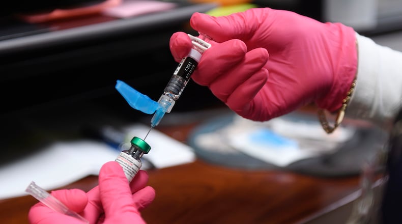 FILE - Anna Hicks prepares a measles, mumps and rubella vaccine at the Andrews County Health Department, Tuesday, April 8, 2025, in Andrews, Texas. (AP Photo/Annie Rice, File)