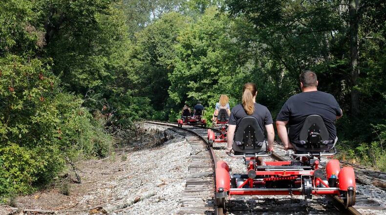 Visitors riding "Rail Explorers" pedal over train tracks in Versailles from the Bluegrass Scenic Railroad and Museum. (Olivia Anderson/Lexington Herald-Leader/TNS)