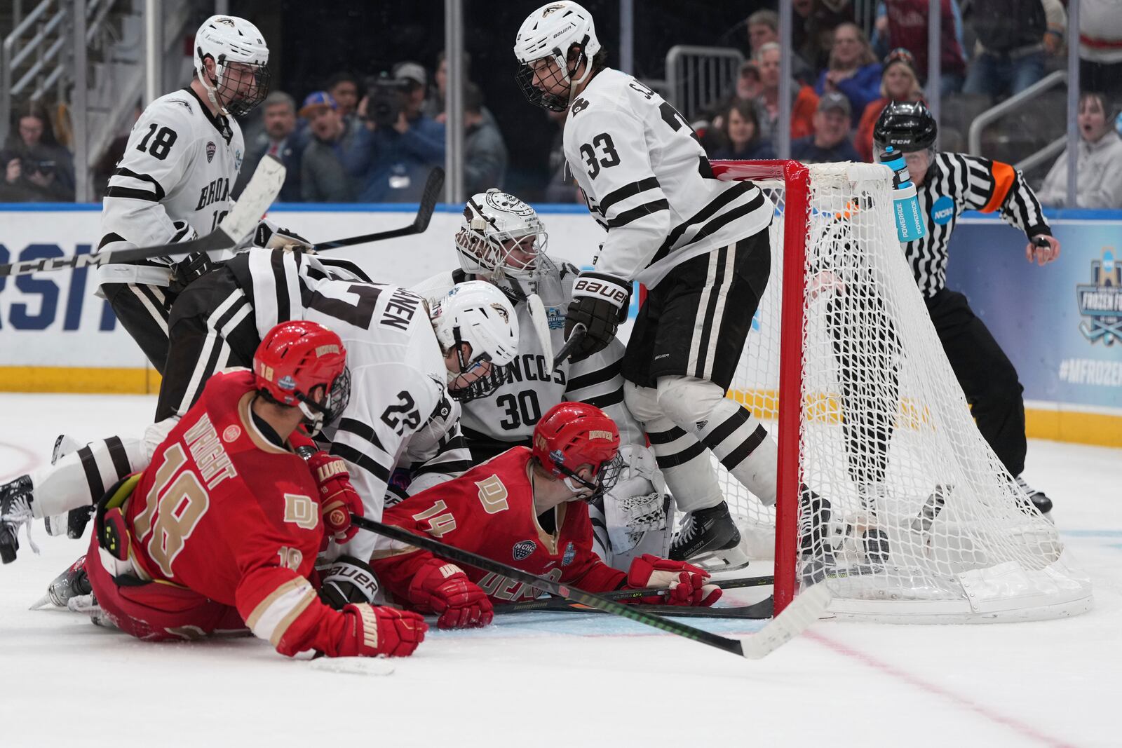 Denver's Rieger Lorenz (14) scores past Western Michigan goaltender Hampton Slukynsky (30) during the third period in a semifinal game in the NCAA Frozen Four men's college hockey tournament, Thursday, April 10, 2025, in St. Louis (AP Photo/Jeff Roberson)