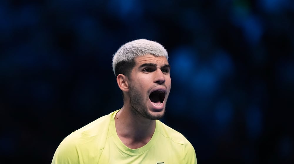 Spain's Carlos Alcaraz celebrates after winning against Italy's Lorenzo Musetti during the tennis match of the ATP World Tour Finals, in Turin, Italy, Thursday, Nov. 13, 2025. (AP Photo/Antonio Calanni)