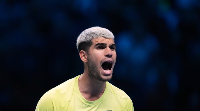Spain's Carlos Alcaraz celebrates after winning against Italy's Lorenzo Musetti during the tennis match of the ATP World Tour Finals, in Turin, Italy, Thursday, Nov. 13, 2025. (AP Photo/Antonio Calanni)