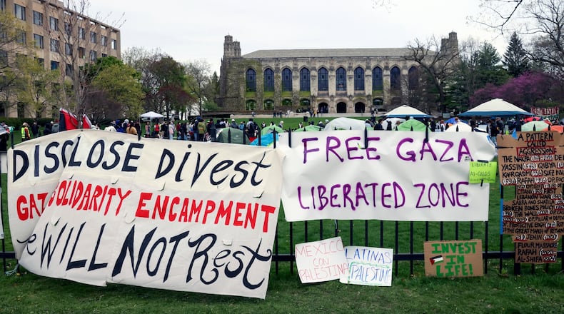 FILE - Signs are displayed outside a tent encampment at Northwestern University on April 26, 2024, in Evanston, Illinois. (AP Photo/Teresa Crawford, file)