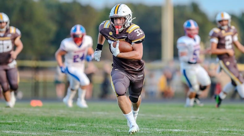 Kenton Ridge High School senior Jackson Patton carries the ball during their game against Northwestern on Friday, Sept. 13 at Richard L. Phillips Field in Springfield. The Cougars won 27-21 in double overtime. Michael Cooper/CONTRIBUTED